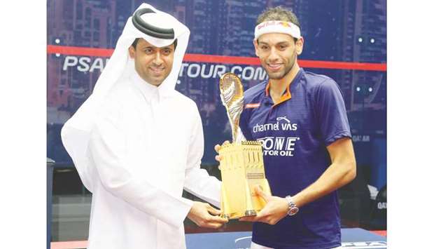 Qatar Tennis, Squash and Badminton Federation president Nasser al-Khelaifi (left) presents the winneru2019s trophy to Mohamed El Shorbagy (also below) after he won the Qatar Classic squash title yesterday. PICTURES: Jayan Orma