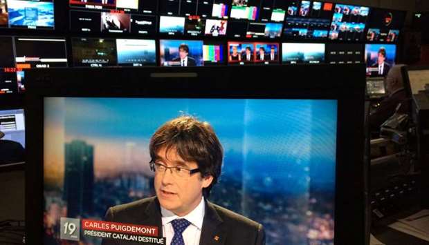Ousted Catalan President Carles Puigdemont appears on a monitor during a live TV interview at the Belgian RTBF studio in Brussels, Belgium.