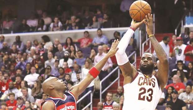 LeBron James of the Cleveland Cavaliers puts up a shot over Jodie Meeks of the Washington Wizards in the first half of their game at Capital One Arena in Washington, DC.