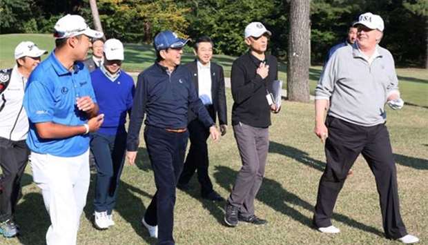 Japanese Prime Minister Shinzo Abe (front centre left) shares a light moment with US President Donald Trump while playing golf with Japanse professional golfer Hideki Matsuyama (front left) at the Kasumigaseki Country Club in Kawagoe, Saitama prefecture, outside Tokyo on Sunday.