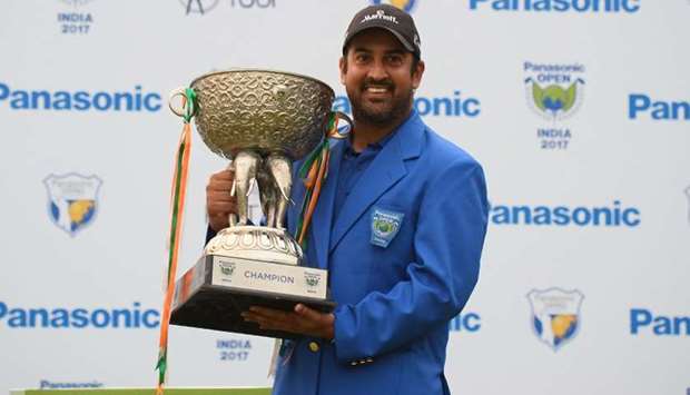 Indian golfer Shiv Kapur poses with the winning trophy