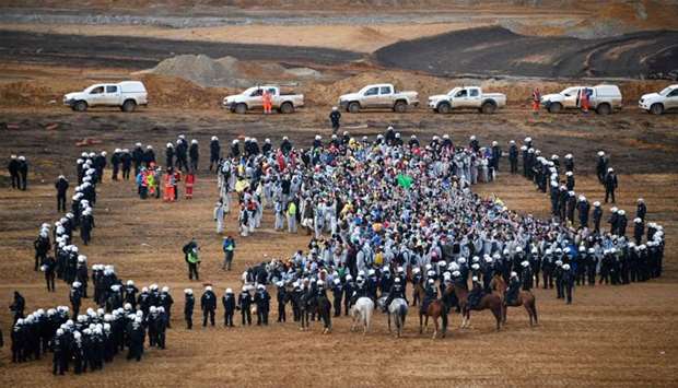 Policemen encircle environmentalists who managed to enter the Hambach lignite open pit mine near Els