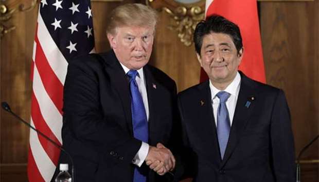 US President Donald Trump shakes hands with Japan's Prime Minister Shinzo Abe during a news conference at Akasaka Palace in Tokyo on Monday.