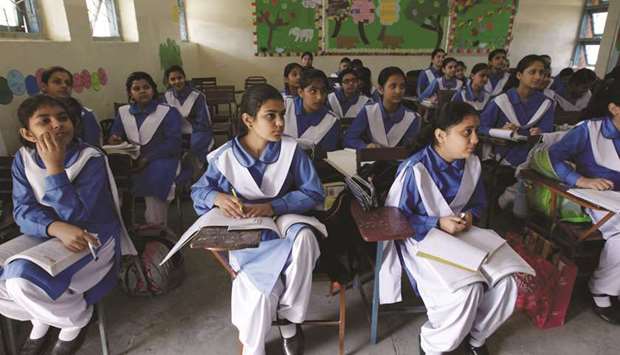 Students listen to their teacher during a lesson at the Islamabad College for girls in Islamabad.