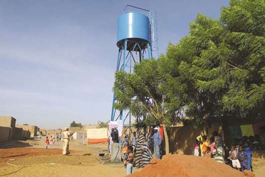 People draw water from a brand new well after its inauguration in the Tagoute area of Gao.