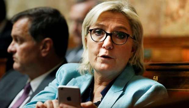 Marine Le Pen holding her mobile phone as she attends a session of questions to the government at the French National Assembly in Paris. File photo taken on October 17, 2017