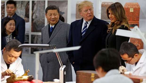 US President Donald Trump (back 2nd R), First Lady Melania Trump (back R) and China's President Xi Jinping (back L) tour the Conservation Scientific Laboratory of the Forbidden City in Beijing.