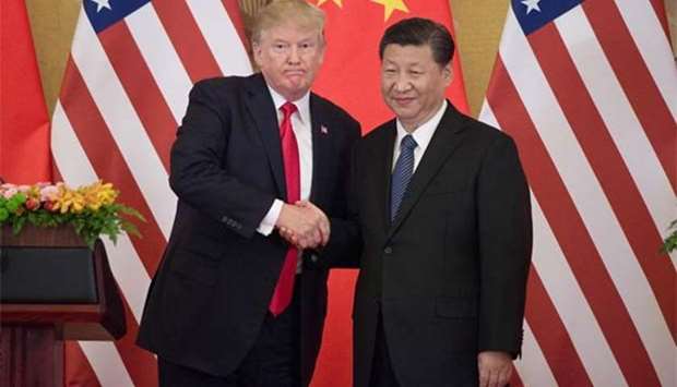 US President Donald Trump shakes hands with China's President Xi Jinping during a press conference at the Great Hall of the People in Beijing on Thursday.