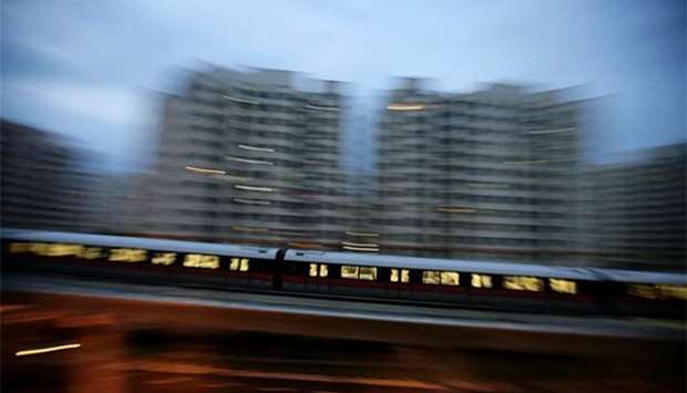 An MRT train travels along a track in Singapore.