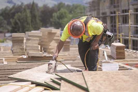 A contractor uses a hand saw while working on a townhouse under construction at a housing development in San Jose. Fannie Maeu2019s first initiative, which hasnu2019t been finalised, would potentially make it cheaper and simpler for prospective home-buyers to get loans to construct new residences.
