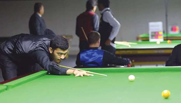 Indiau2019s Dhvaj Haria (left) in action against Englandu2019s Mike Russell (unseen) during their round robin stage match at the IBSF World Billiards Championship match at Al Arabi Sports Club yesterday. PICTURES: Ram Chand