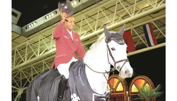 Qataru2019s Bassem Hassan Mohamed celebrates his win on Argelith Squid in the CSI5* Against the clock (1.50m) Table A, FEI Art. 238.2.1, at Al Shaqab Arena yesterday. PICTURES: Lotfi Garsi