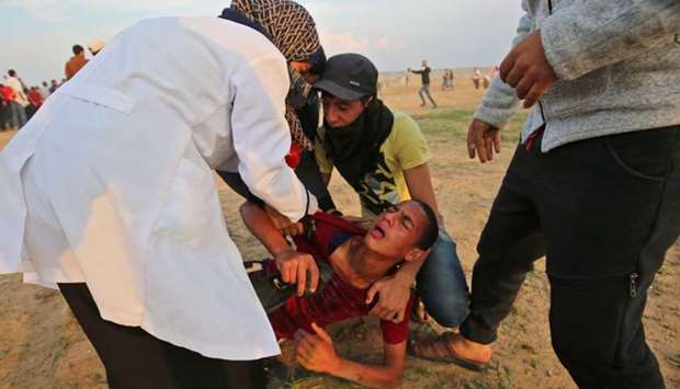 A wounded protester is evacuated during clashes near the border between Israel and Khan Yunis in the southern Gaza Strip