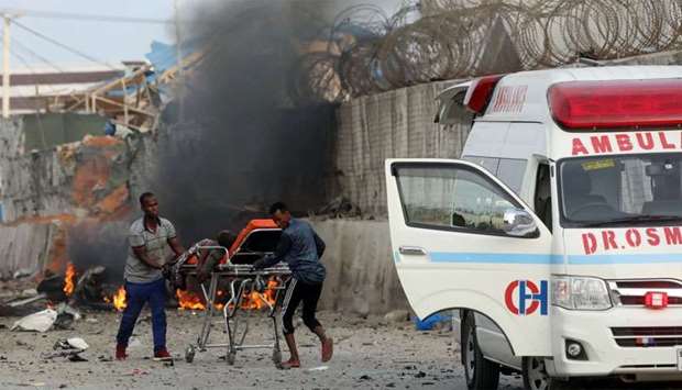 Somali rescue workers carry a man injured from the explosion in Mogadishu