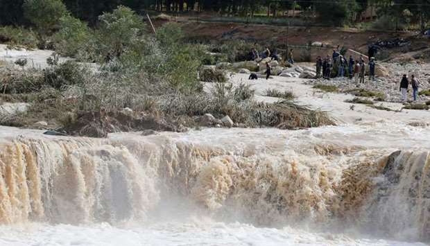 Civil defense members look for missing persons after rain storms unleashed flash floods, in Madaba city