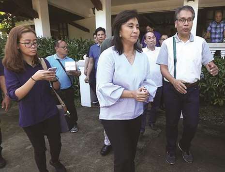 Vice President Maria Leonor u2018Leniu2019 Robredo is escorted by senatorial hopeful and former Interior and Local Government secretary Manuel u2018Maru2019 Roxas, outside his residence in Capiz after meeting with local leaders of the province.