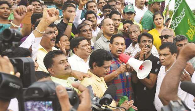 Sri Lankan politician Rajitha Senaratne, centre, addresses a rally of supporters of deposed prime minister Ranil Wickremesinghe in Colombo to protest against the actions of President Maithripala Sirisena.