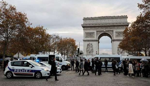 Security personel gather ahead of a commemoration ceremony for Armistice Day, 100 years after the end of the First World War at the Arc de Triomphe, in Paris