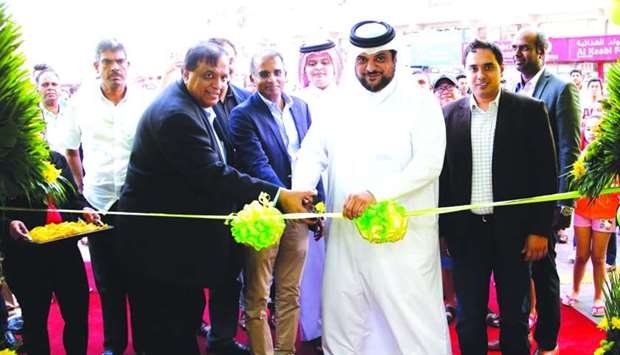 Sheikh Hamad bin Jassim MA al-Thani and Peter Mathews lead the ribbon-cutting ceremony to open the first Amana Puregold in the region in Doha. PICTURES: Jayaram