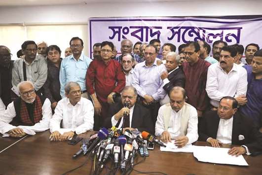 Members of Jatiya Oikyafront, an opposition alliance, hold a news conference at the National Press Club to confirm their participation in the upcoming parliamentary election in Dhaka yesterday.