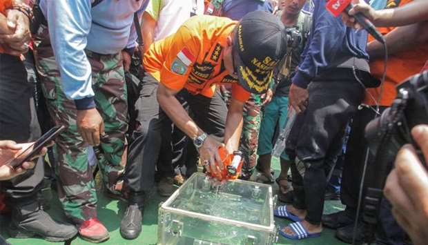 Chief of National Search and Rescue Agency Muhammad Syaugi holds a part of the black box of Lion Air's flight JT610 airplane