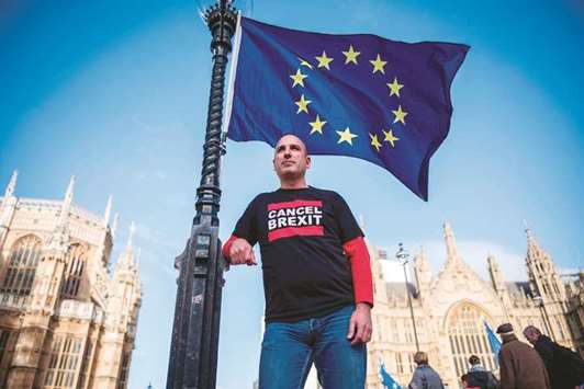 Spanish nurse and anti-Brexit campaigner Joan Pons Laplana poses for a photograph in front of an EU flag outside the Houses of Parliament in London.