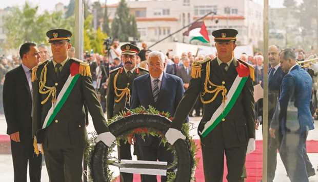 Palestinian President Mahmoud Abbas lays a wreath at the tomb of late leader Yasser Arafat inside the Mukataa compound, in the the West Bank city of Ramallah.