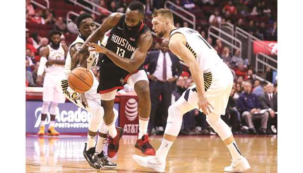 Houston Rockets guard James Harden (centre) splits the defence of Indiana Pacers guard Victor Oladipo (left) and forward Domantas Sabonis during the NBA match in Houston on Sunday. (USA TODAY Sports)