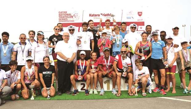 Medal winners pose with the officials after the inaugural Katara Triathlon organised by the Qatar Triathlon Federation.