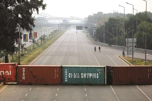 Shipping containers are seen near Islamabadu2019s Faizabad junction, placed by the authorities to stop protesters after the Supreme Court overturned the conviction of a Christian woman sentenced to death for blasphemy against Islam.