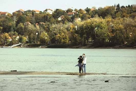 A couple stands on a sandbank which emerged amid Danube Riveru2019s lowest water levels this year, in Novi Sad, Serbia.