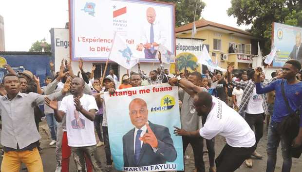 Supporters of Congolese presidential candidate Martin Fayulu celebrate in Kinshasa after the opposition coalition chosen him to be the candidate in a December presidential election.