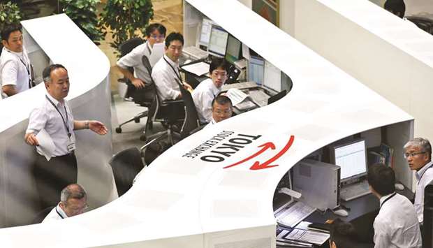 Employees work at the Tokyo Stock Exchange. The Nikkei 225 closed down 0.1% to 22,237.19 points yesterday.