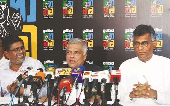 Ranil Wickremesinghe speaks to media after Supreme Court suspended a presidential decree to dissolve parliament and hold fresh elections, during a news conference in Colombo, yesterday.