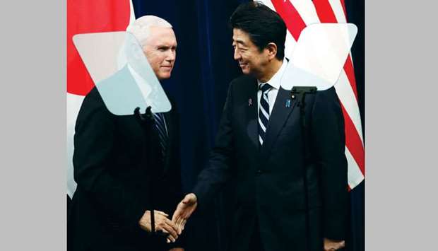 US Vice President Mike Pence and Japanese Prime Minister Shinzo Abe reach out to shake hands behind teleprompters at their joint news announcement at Abeu2019s official residence in Tokyo, Japan.