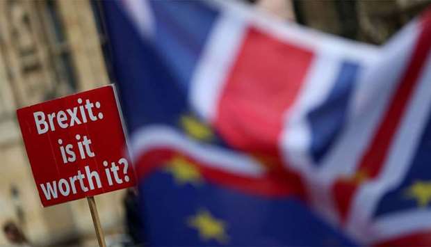 A sign that reads ,Brexit. Is it worth it?, whilst draped in European Union (EU) and Union flags