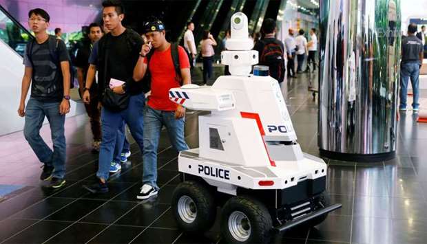 A police surveillance robot patrols the lobby of Suntec Convention Center during the ASEAN Summit in Singapore