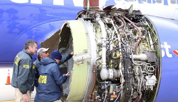 US NTSB investigators are on scene examining damage to the engine of the Southwest Airlines plane in this image released from Philadelphia, Pennsylvania on April 17, 2018.