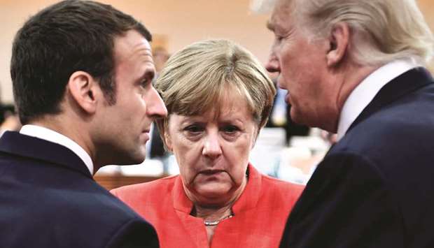 NOT SEEING EYE TO EYE: This file picture taken last year shows Trump, Macron, and Merkel.