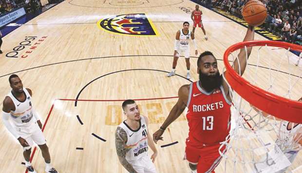 Houston Rockets guard James Harden (right) drives to the net ahead during the game against Denver Nuggets in Denver, Colorado, on Tuesday. (USA TODAY Sports)