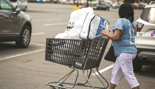 A customer pushes a shopping cart while exiting a store in Charlotte, North Carolina. The US Labour Department said yesterday its Consumer Price Index rose 0.3% last month after edging up 0.1% in September.