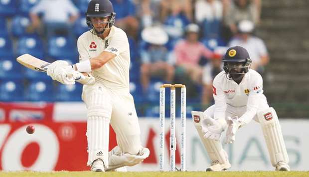 Englandu2019s Sam Curran plays a reverse sweep as Sri Lankau2019s wicketkeeper Niroshan Dickwella looks on during the second Test in Pallekele, Sri Lanka yesterday. (Reuters)