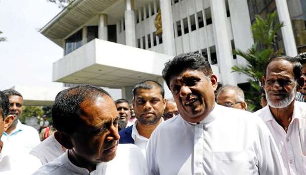 Sajith Premadasa deputy leader and Kabir Hashim senior member of the deposed Prime Minister Ranil Wickremesinghe-led United National Party, talk as they leave the Supreme Court in Colombo