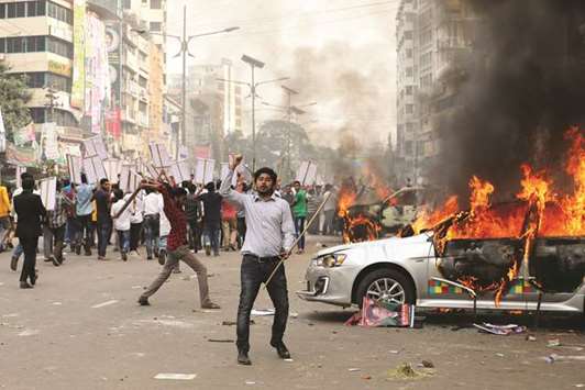 BNP activists set fire to a police vehicle during clashes in Dhaka yesterday.