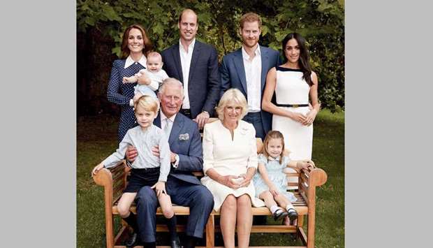 Prince Charles, Prince of Wales, holds Prince George for an official portrait to mark his 70th birthday with Prince Louis of Cambridge, Catherine, Duchess of Cambridge, Prince William, Duke of Cambridge, Prince Harry, Duke of Sussex, Meghan, Duchess of Sussex, Camilla, Duchess of Cornwall and Princess Charlotte.