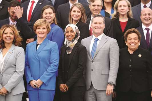 Democratic Representative-elect Ilhan Omar of Minnesota, one of the first Muslim women elected to Congress, poses in the front row with other incoming newly-elected members of the US House of Representatives on Capitol Hill in Washington yesterday.