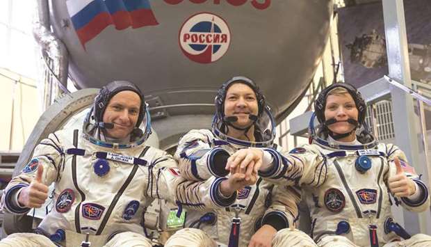 Members of the International Space Station (ISS) expedition 58/59, Russian cosmonaut Oleg Kononenko (centre), Nasa astronaut Anne McClain (right) and David Saint-Jacques of the Canadian Space Agency, pose during their final exam yesterday at the Gagarin Cosmonautsu2019 Training Centre near Moscow.