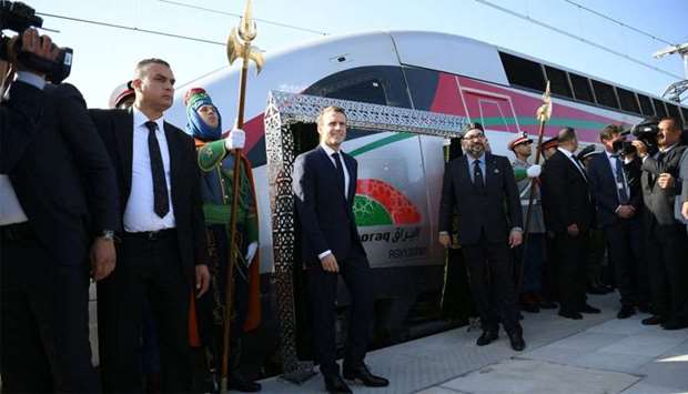 French President Emmanuel Macron and Moroccan King Mohammed VI pose for a photograph as they inaugurate a high-speed line at Rabat train station