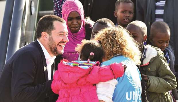 Italyu2019s Interior Minister and deputy PM Matteo Salvini welcomes children from a group of 51 migrants from Niger upon their arrival at the Mario De Bernardi military airport in Pratica di Mare, south of Rome.
