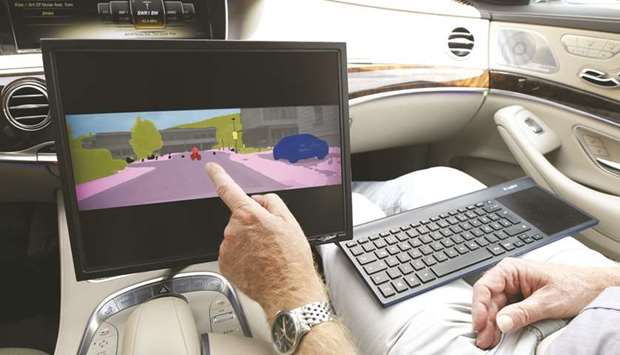 A cyclist is colour-coded on a monitor inside a Mercedes-Benz S-Class automobile during the Daimler Tech Day autonomous driving and artificial intelligence (AI) demonstration on a town street in Immendingen, Germany on July 17. Chancellor Angela Merkel has made fixing the countryu2019s digital deficiencies a priority for her fourth and almost certainly final term, and called that a prerequisite for its future prosperity.